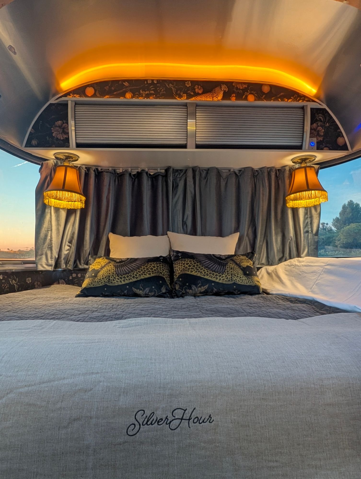 Bed with fringed lamps and leopard print